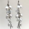 3 inch long earrings made of teardrop shaped pearls and crystals in a cascade down a silver chain