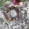 rosary bracelet with crazy horse stone and goldtone beads on memory wire