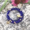 rosary bracelet with dark navy blue glass and goldtone beads on memory wire
