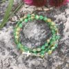 rosary bracelet with green and yellow crackle glass and silvertone beads on memory wire