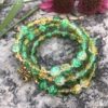 rosary bracelet with green and yellow crackle glass and goldtone beads on memory wire