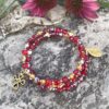 rosary bracelet with red heart shaped Czech glass and goldtone beads on memory wire