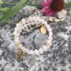 rosary bracelet with rose quartz and goldtone beads on memory wire