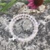 rosary bracelet with rose quartz and silvertone beads on memory wire