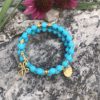 rosary bracelet with turquoise and goldtone beads on memory wire