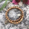 rosary bracelet with wood jasper and goldtone beads on memory wire